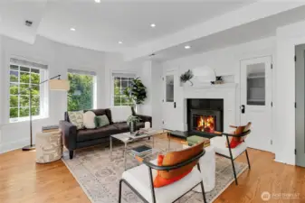 Cozy main living room anchored by a fireplace that serves as the warm focal point of the space.