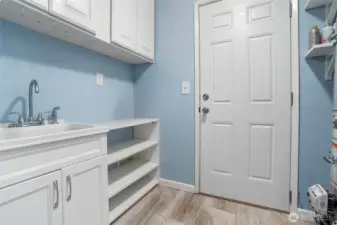 Mudroom and the door leads outside.  New gas furnance and hotwater tank live here.