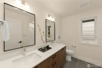 Upper full bath with dual sinks.