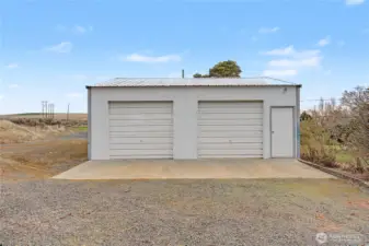 Detached 2 car shop and there's a 2 car overside carport behind