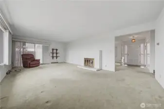 Living room with gas fireplace and walk out to the backyard patio and deck.