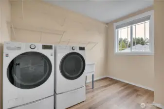 Laundry Room with storage shelves, utility sink, and LG ThinQ Washer and Dryer Set