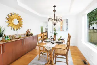 Formal dining room with serving countertop leads into kithcen
