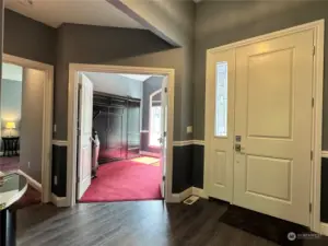 Inside view of the front door, with the hallway to the 2nd bedroom with ensuite. The double doors lead to the 3rd bedroom.