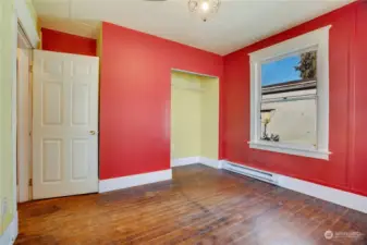 This room faces north with a set of windows over the front yard and this side window to the west.