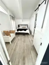 Primary room.  New Queen bed with barn door to gorgeous remodeled bathroom.