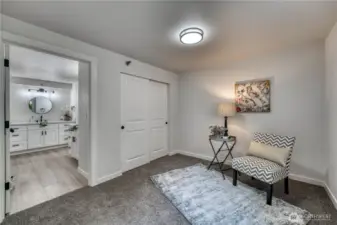 Second bedroom with a peek into bathroom.