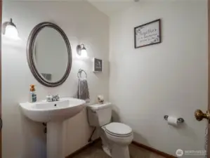 The half bath is located centrally on the main floor, so guests don't have to go upstairs or into the primary suite.