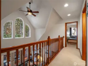 The upstairs hall has a beautiful view of the forest.