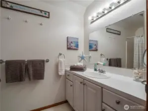 The upstairs full bathroom has ample space and is located between the two bedrooms.