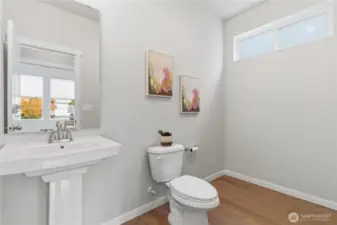 Half bath on the main floor.  Large space under the window is plumbed for a shower (an upgrade the original owners passed on).