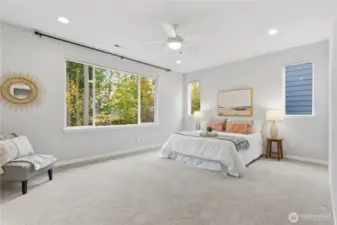 Cheery primary suite with views of the trees