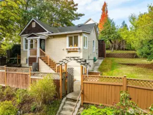This lovely home is perched above the street and fully-fenced, to create an in-city oasis with ample space to play, garden, entertain, and unwind.