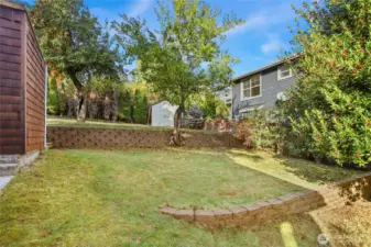 This property has beautiful hardscaped terraces with steps leading up to the storage shed and west side of the property.
