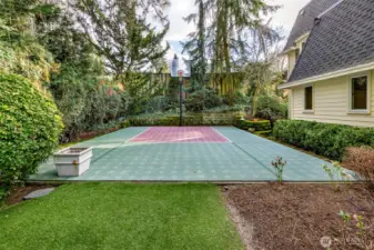Sport court with basketball hoop.