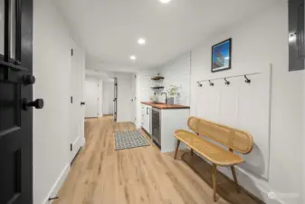 Mud room off of lower level entry leads to wet bar and family room