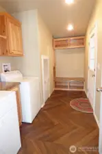 Laundry room from the dining room. Washer and dryer stay too. Door leads to attached double garage.