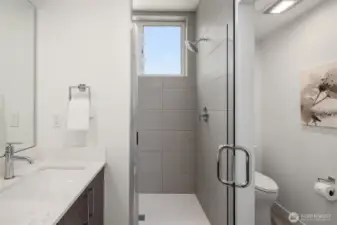Walk in shower with lots of natural light, high ceilings and separate toilet area.