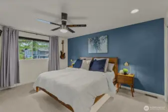 Spacious primary bedroom with double mirror closets, ceiling fan, and ensuite 5-piece bathroom.