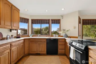 Open kitchen w/ Sound views, casual dining area & den