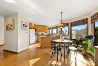 Open kitchen w/ Sound views, casual dining area & den
