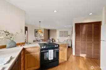 Open kitchen w/ Sound views, casual dining area & den