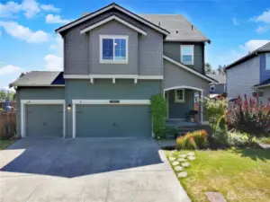 Curb appeal meets comfort! This modern Craftsman features a 3-car garage, charming covered porch, and well-kept landscaping—all nestled on a quiet street with stunning mountain views just around the corner.