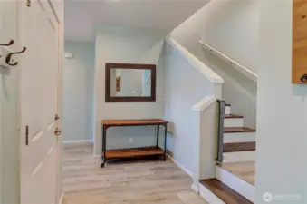 Welcome home! This inviting entryway sets the tone with stylish flooring, modern finishes, and a warm, functional layout that leads you upstairs to the heart of the home.