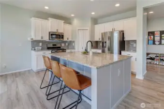 This kitchen checks every box—stylish, spacious, and functional! Featuring granite counters, a large island with seating, stainless steel appliances, and tons of storage for all your cooking essentials.