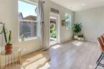 Sunlight pours into this cheerful nook just off the kitchen—perfect for a breakfast area, plant corner, or cozy reading spot with views of the lush backyard.