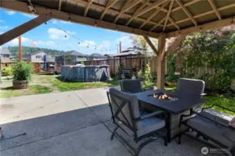This backyard is an entertainer’s dream—featuring a covered patio with fire table, string lights, garden space, BBQ area, and a pool for summer fun! Fully fenced with room to relax, play, and gather.