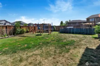 Kid-approved and garden-lover ready! This oversized backyard features a swing set, trampoline, raised garden beds, and an above-ground pool—perfect for play, relaxation, and outdoor fun all year round.