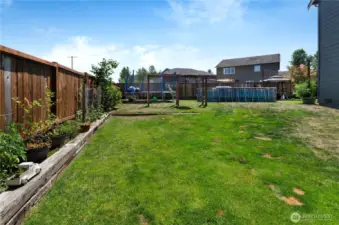 Spacious and fully fenced, this backyard is the ultimate play zone—featuring a large grassy area, swing set, above-ground pool, and garden space. There's room for everyone to enjoy the outdoors!