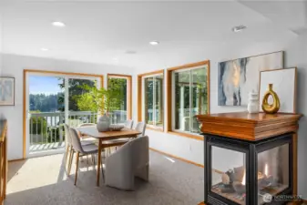A custom multi-sided gas fireplace was installed by current owners. Sliding doors lead to the main level deck with stunnin views of Agate Pass.