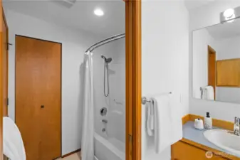 This full bath includes two linen closets plus a walk-in closet.