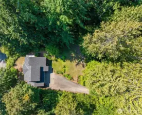 An aerial view of the property - a perfect combination of mature trees and open spaces which bathe the home in natural light all day.