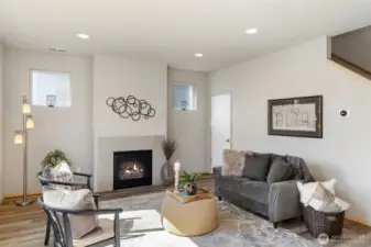 Cozy up by the gas fireplace in this inviting living room with fresh interior paint and flooring.