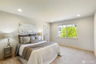 Primary suite retreat with soft new carpet and private bath.