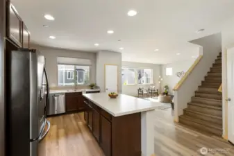 Seamless kitchen-to-living flow with easy upstairs access.