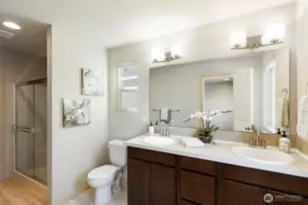 Spa-style bath with dual sinks and modern finishes.