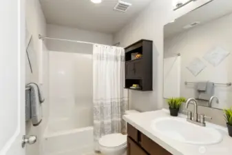 Full bath with tub, shower, and fresh finishes.