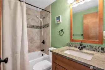 Guest Bath. Nice tile shower and granite top with undermount sink