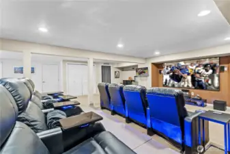 Large basement space designed for family time and entertaining features a full theater setup—ideal for movie nights, game days, and gatherings with friends and family.