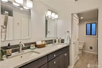 The primary bathroom. The shower and tub are on the right and the dual sinks make getting ready easy.