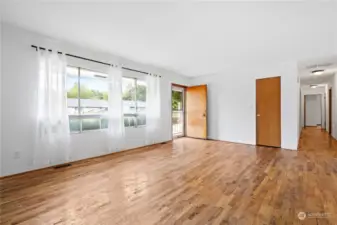 The hardwood floors lend a touch of timeless style, complementing both modern and traditional decor. This room is perfect for relaxing with family or entertaining guests.