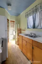 ADU galley kitchen leading to bathroom