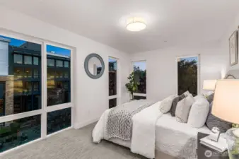 Step into the cozy elegance of this sunlit bedroom. Expansive windows frame serene views while filling the space with natural light, creating the perfect relaxing ambiance.