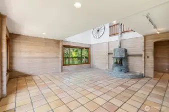 Bright, airy Great Room anchored by a stunning Tulikivi fireplace. Virtual staging included in photos to help spark your imagination.
