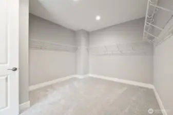 A walk-in closet large enough for a fashionistas extensive wardrobe.