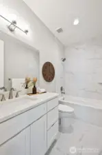 An extra, and elegant, full bathroom on the main level provides flexibility of room use. Conveniently located just across the hall from the den/office.
